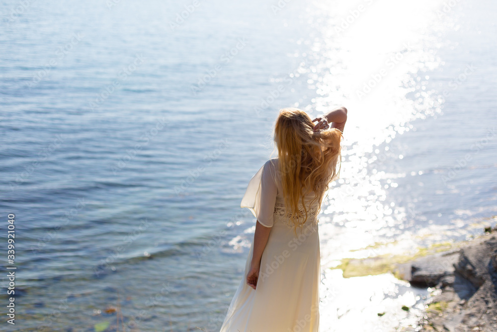 Blonde model on the sea at summer 