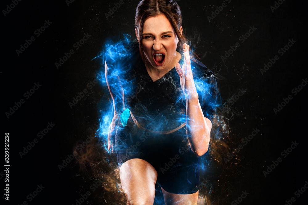 Sprinter and runner girl. Running concept. Fitness and sport motivation. Strong and fit athletic, woman sprinter or runner, running on black background in the fire wearing sportswear.