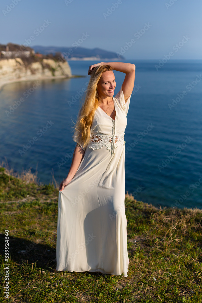Blonde model at the sea at summer