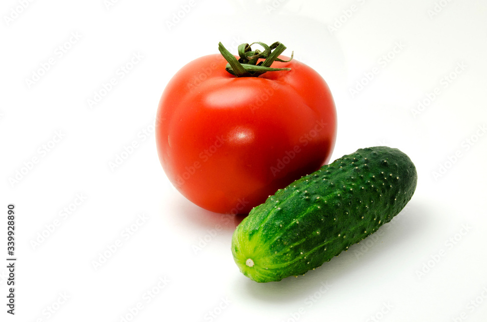 Red tomato and cucumber photo on a white background Red tomato and cucumber photo on a white background