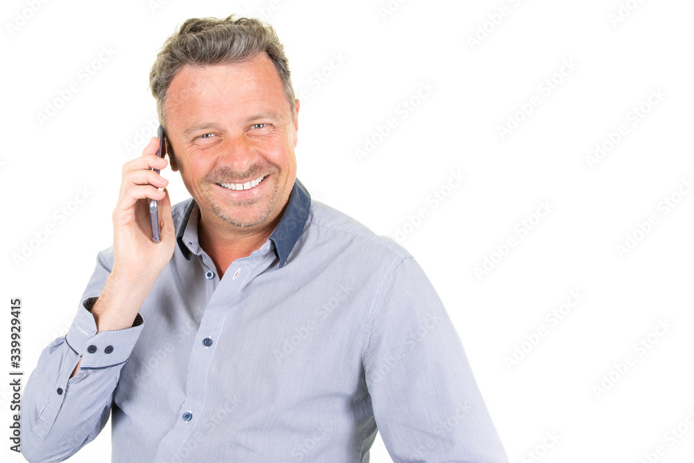 Happy young man talking by mobile phone aside blank copy space in white background Happy young man talking by mobile phone aside blank copy space in white background