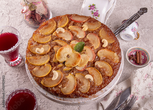 French sweet pie tart tatin apple cake upside down  over on gray concrete background. photo