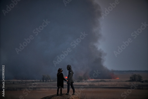  man and woman look at the fire