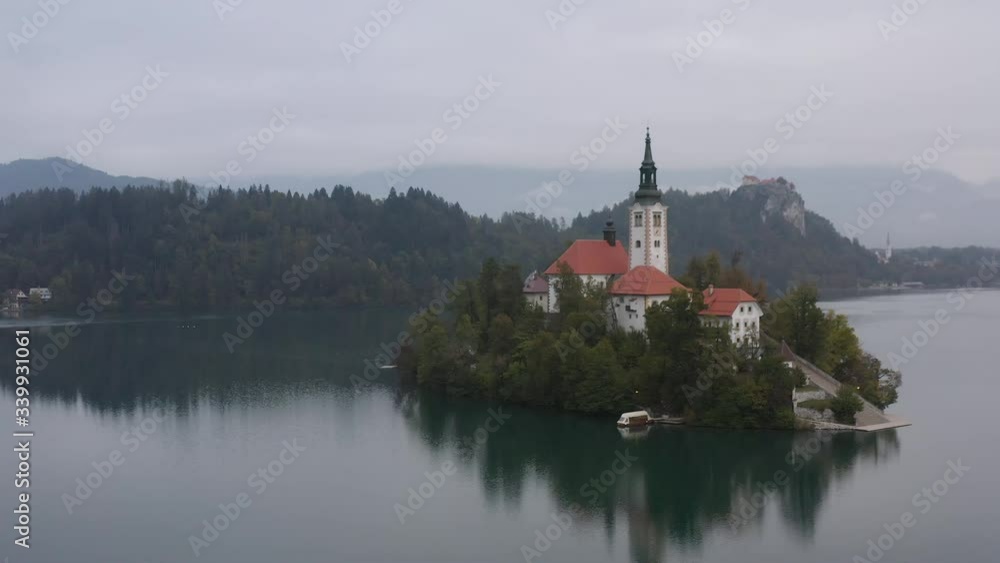 Flight over of Bled Island (Blejski otok) with pilgrimage church of the Assumption of Mary and Bled castle on Lake Bled Flight over of Bled Island (Blejski otok) with pilgrimage church of the Assumption of Mary and Bled castle on Lake Bled
