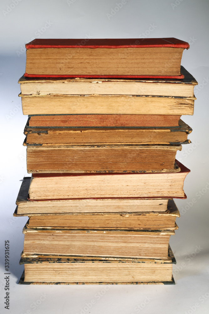 Composition of old books, with yellowed and ruined pages. Light background. Composition of old books, with yellowed and ruined pages. Light background.