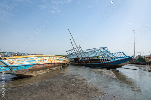 Old and abandoned ships anchored in Banjul Bay  at low tide.
