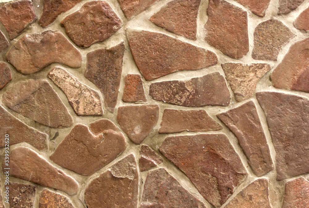 concrete wall with large fragments of broken stone