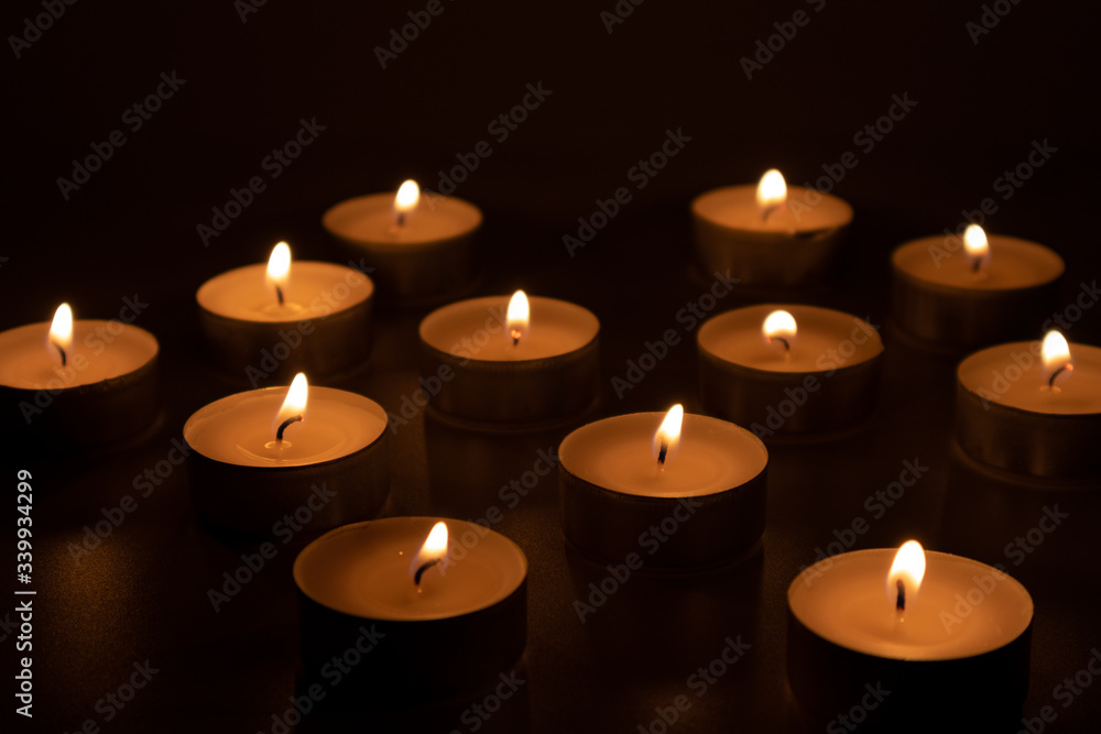 Burning candles in the dark, feeling of sadness and sorrow Burning candles in the dark, feeling of sadness and sorrow
