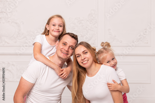 Young family gather around and smile for photo at father's day