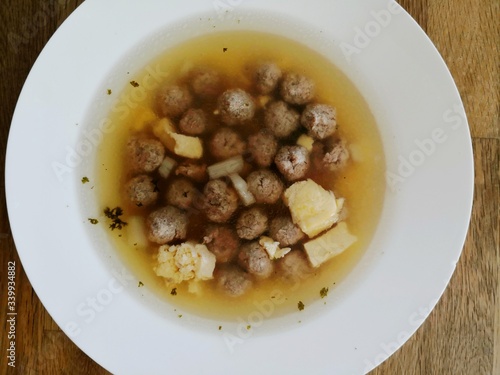 traditional northern German soup with beef, noodles and vegetable, wedding soup on brown wooden background photo