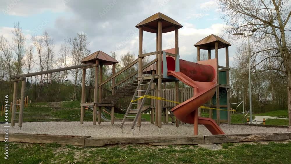 Empty children's playground with warning tape during COVID-19 epidemics Empty children's playground with warning tape during COVID-19 epidemics
