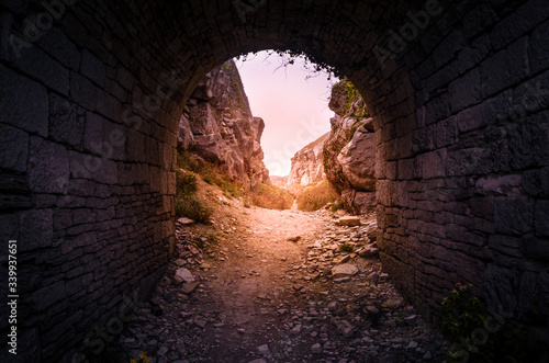 Obraz na płótnie Old quarry bridge with golden sunlight shining through at Tout Quarry, Isle of Portland, Weymouth, Dorset, United Kingdom w salonie