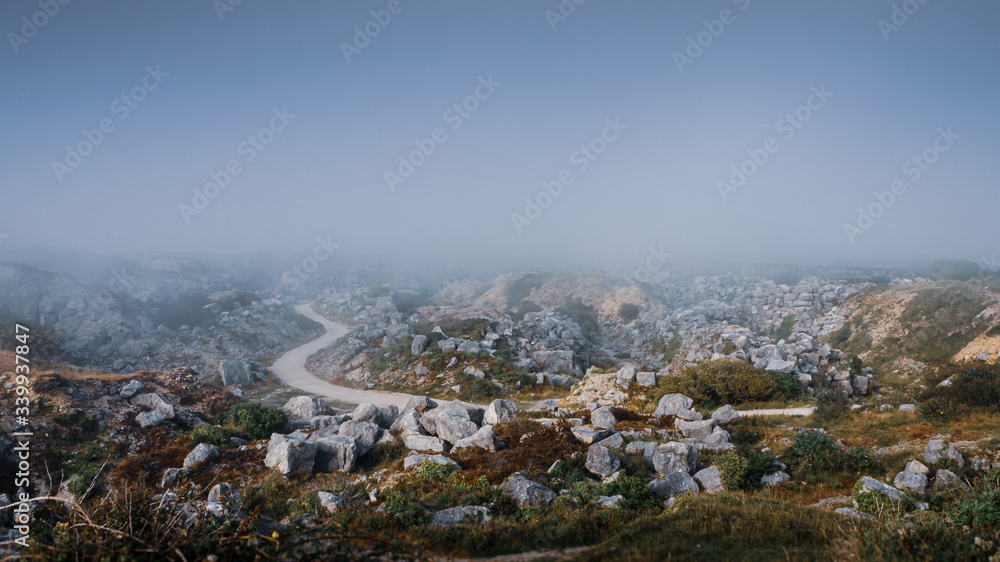 Atmospheric view overlooking a deserted Tout Quarry sculpture park and nature reserve on a foggy summer afternoon, Isle of Portland, Dorest, UK