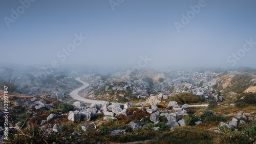 Obraz na płótnie Atmospheric view overlooking a deserted Tout Quarry sculpture park and nature reserve on a foggy summer afternoon, Isle of Portland, Dorest, UK w salonie