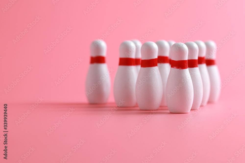 Closeup of a wooden mini bowling game set and pins on pink background Closeup of a wooden mini bowling game set and pins on pink background
