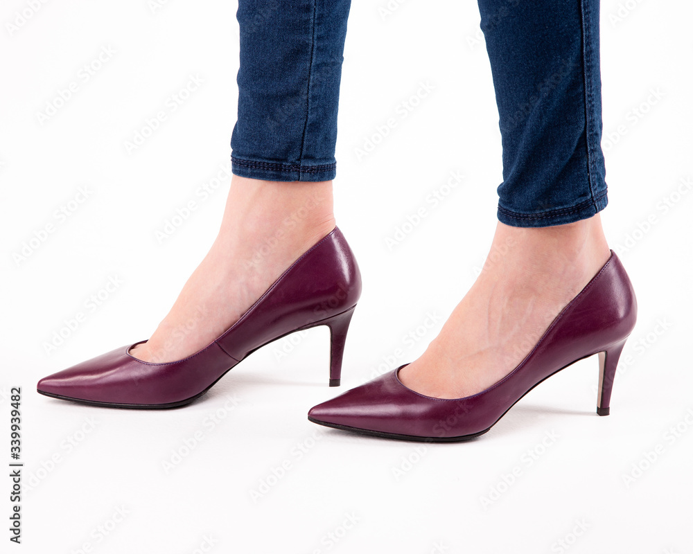 Stylish fashionable women's shoes on legs on a white background in studio Stylish fashionable women's shoes on legs on a white background in studio