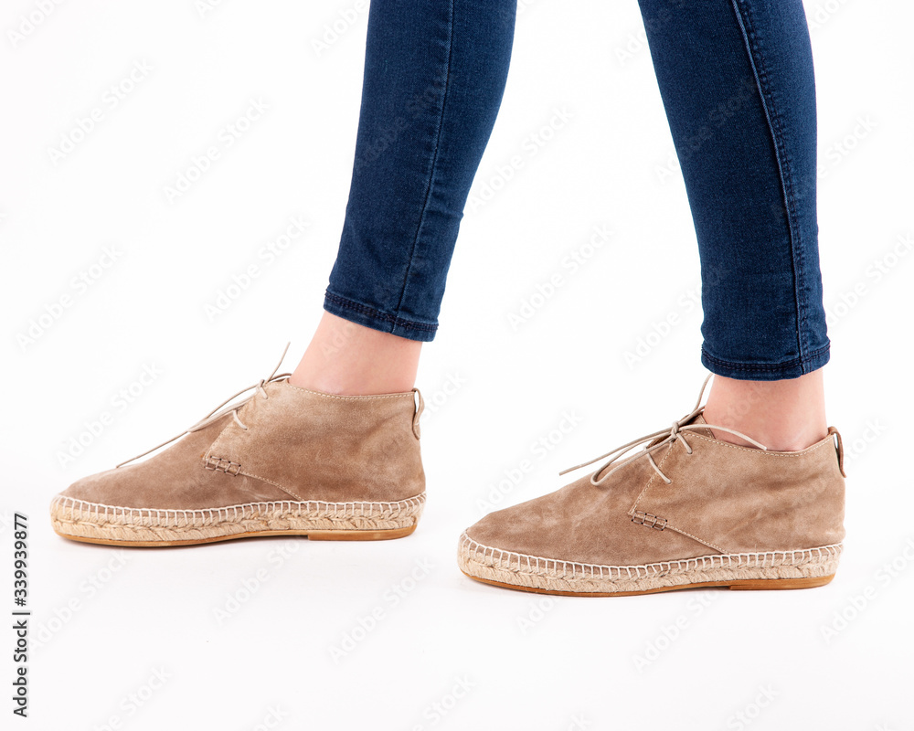 Stylish fashionable women's shoes on legs on a white background in studio Stylish fashionable women's shoes on legs on a white background in studio