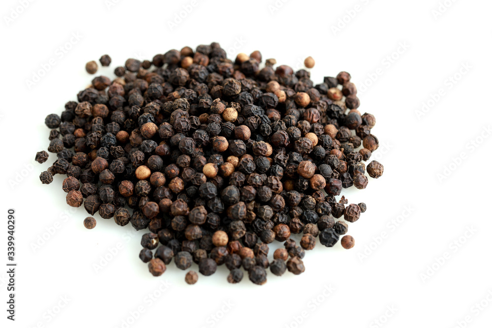 Pile of black peppercorns isolated on white Pile of black peppercorns isolated on white