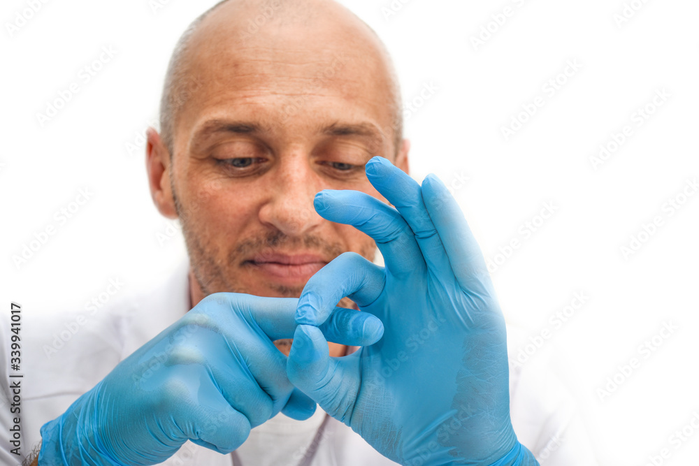 Adult Male Doctor In Blue Rubber Gloves Demonstrating Simulated Sexual 
