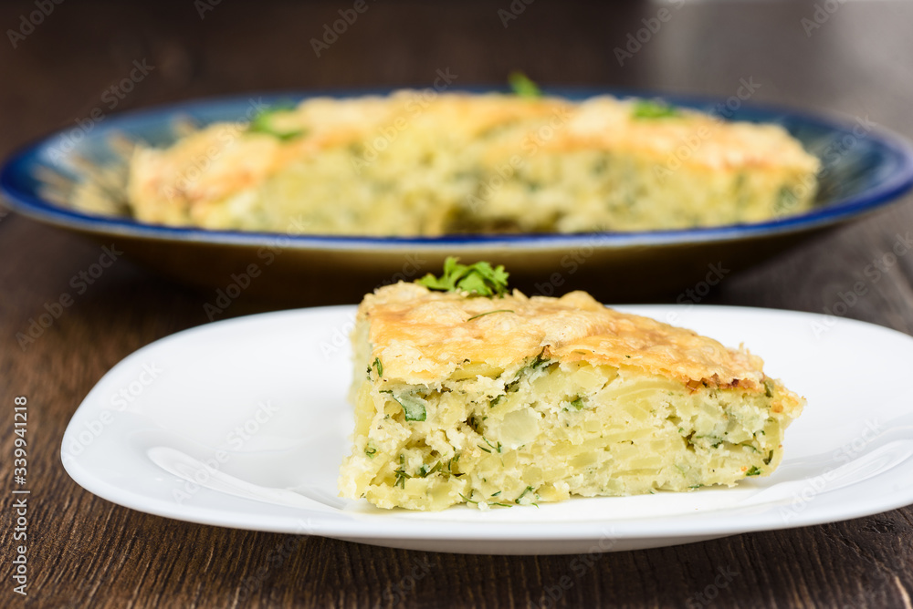 Slice of Turkish berek dish with cheese on a white plate. Slice of Turkish berek dish with cheese on a white plate.