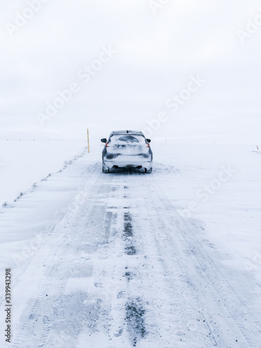 car on icelandic road with snow and ice 
