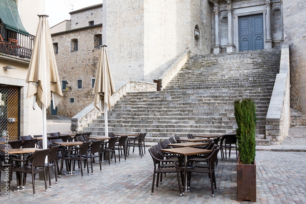 Empty street cafe against catheral in Girona, province Barcelona.