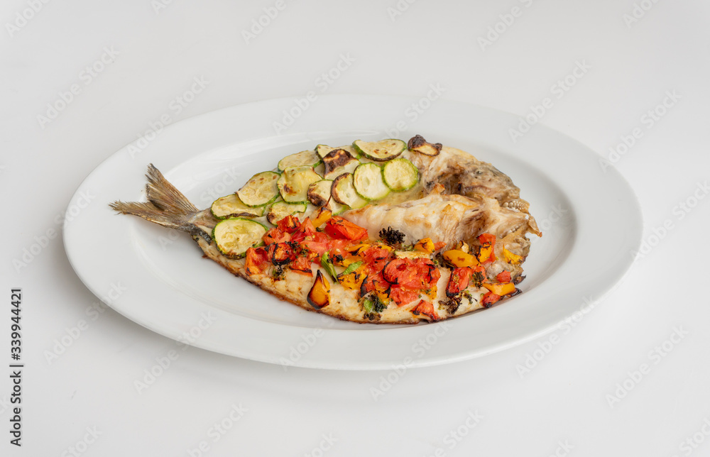 Baked fish with vegetables, zucchini and tomatoes Baked fish with vegetables, zucchini and tomatoes