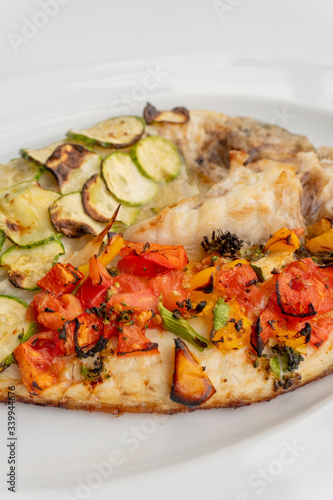 Baked fish with vegetables  zucchini and tomatoes