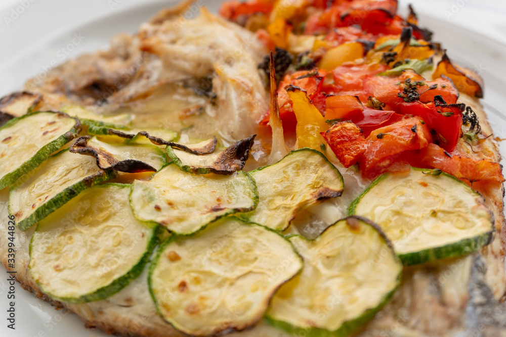 Baked fish with vegetables, zucchini and tomatoes Baked fish with vegetables, zucchini and tomatoes