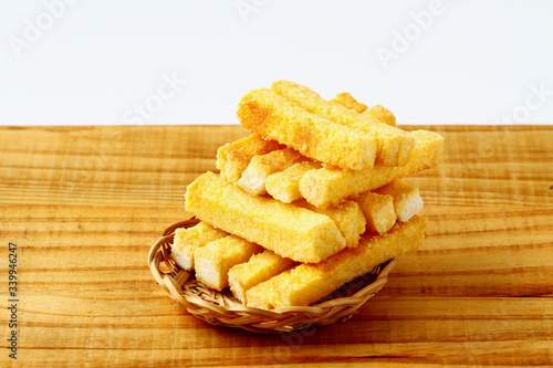 crispy butter and sugar bread in bamboo basket on wooden board. snack for relax time