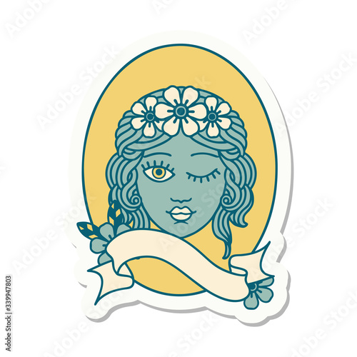 tattoo sticker with banner of a maiden with crown of flowers winking