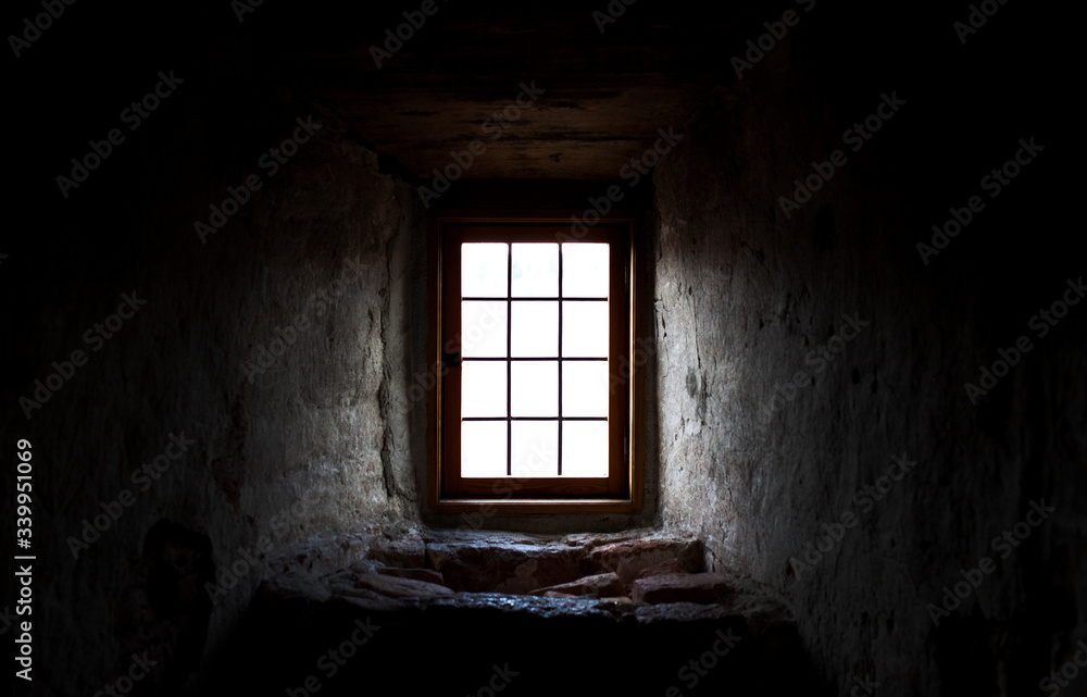 Old castle window in a dark corner Old castle window in a dark corner