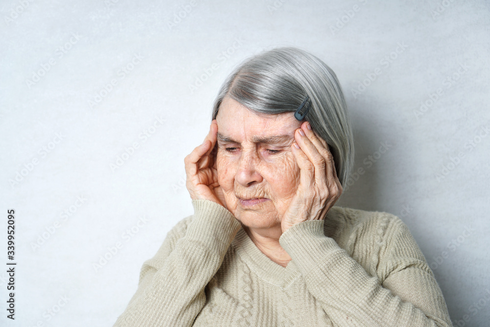 Old woman has a headache. Aged woman holding her head. Old woman has a headache. Aged woman holding her head.
