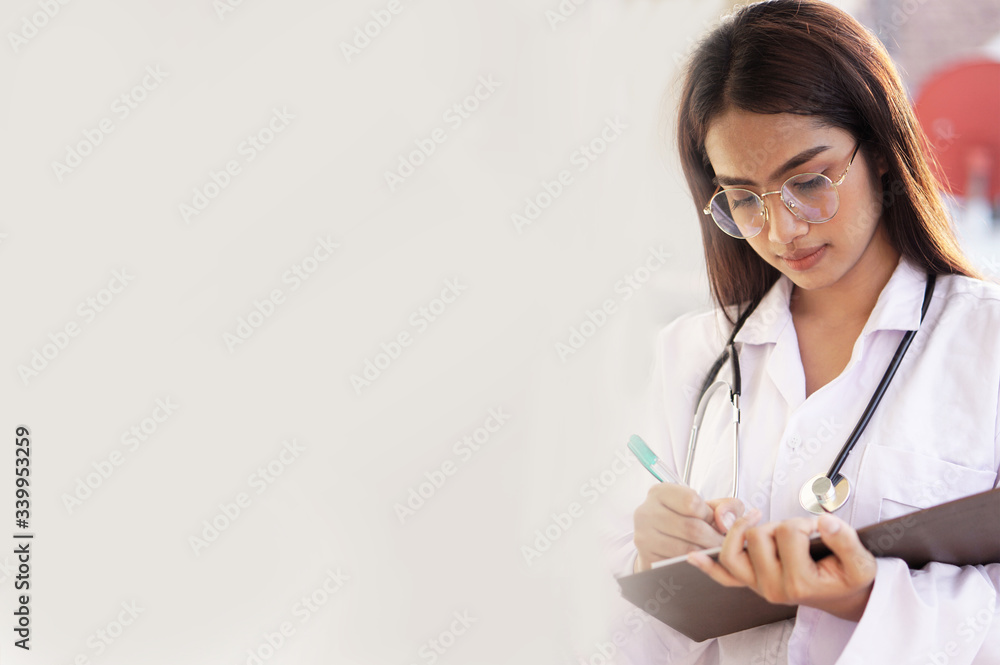 Young Asian woman the doctor doing a record in book concept. Young Asian woman the doctor doing a record in book concept.