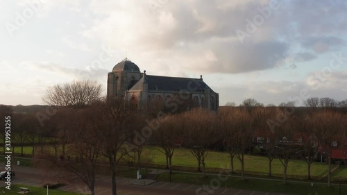 Revealing shot of the big Church of Veere from the canal. Low to high angle drone shot. photo