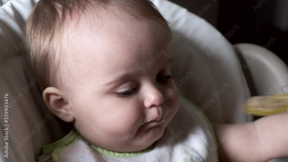Woman feeding child with spoon. Close-up. Slow motion. Woman feeding child with spoon. Close-up. Slow motion.