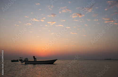 Speed boats and sunset at Busaiteen beach, Bahrain