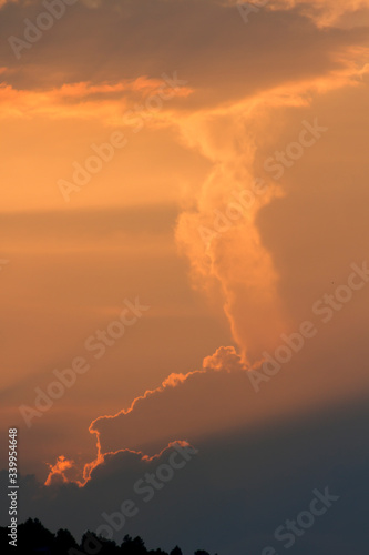 sunset orange and yellow cumulus clouds in a summer day