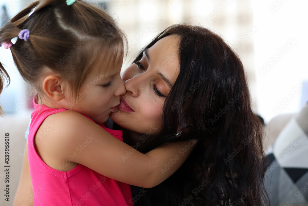 Mother kissing little child