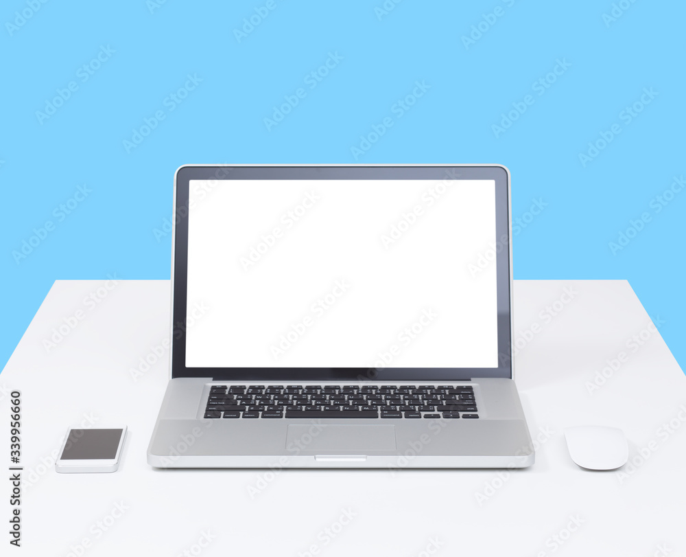 Laptop computer on desk with isolated screen for mockup on blue background. business and technology concept Laptop computer on desk with isolated screen for mockup on blue background. business and technology concept