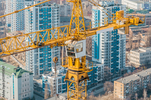 Construction. The jib of a tower crane on the background of the city.