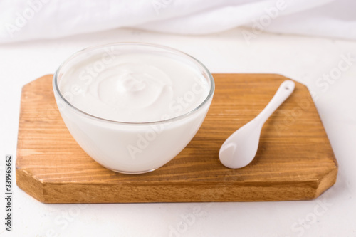 Dahi Indian milk snack on a wooden board on a white background