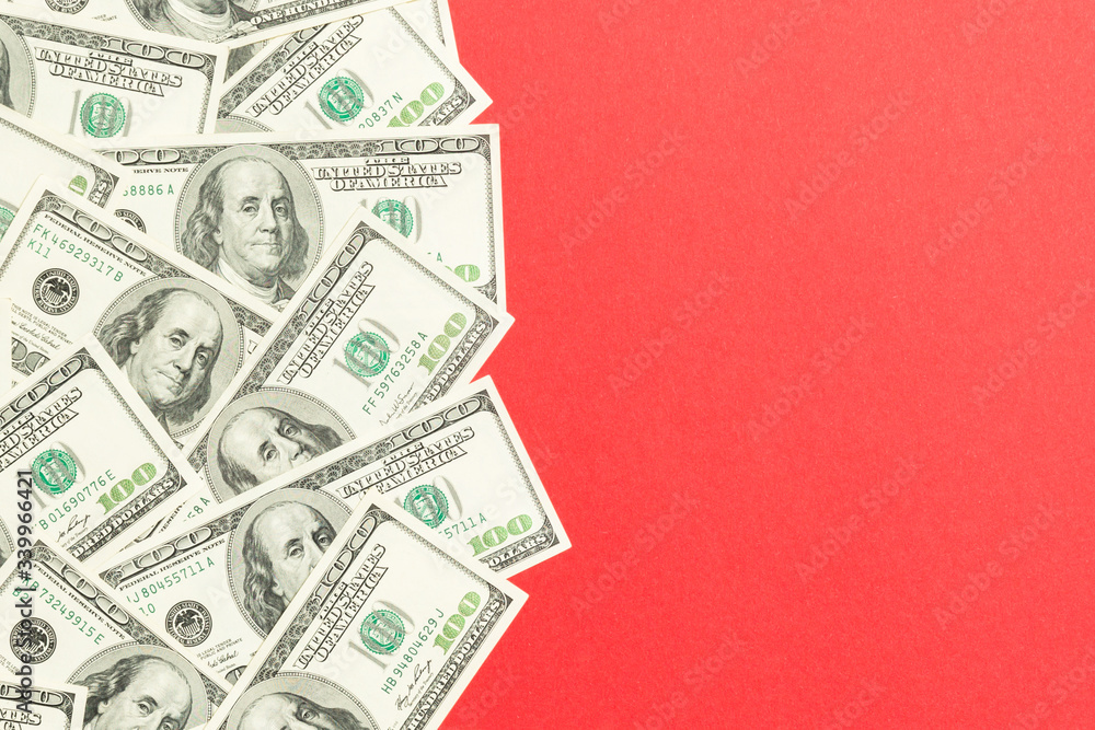 Top view banknotes on colored desk with copy space on top. one hundred dollar bills with stack of money in the middle. Top view of business concept