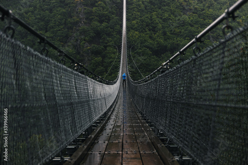Fototapeta Naklejka Na Ścianę i Meble -  Huge Hanging Rope Bridge in Rain
