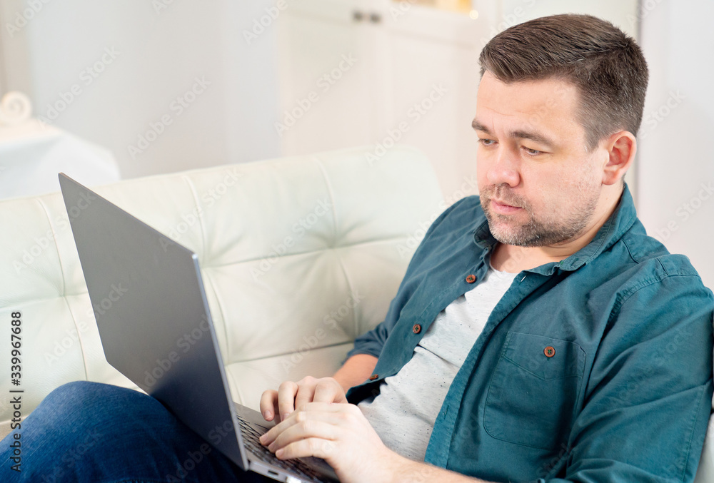 man blogger working online lying on the couch. man blogger working online lying on the couch.