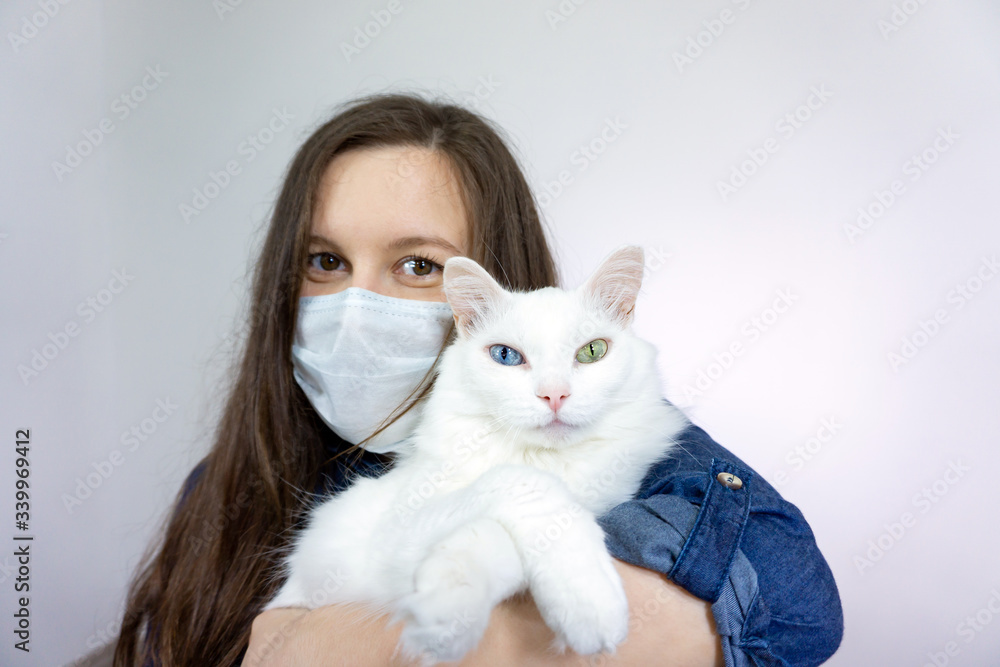 woman with cat, wearing a health mask, isolated in the background, flu epidemic, dust Allergy, virus protection woman with cat, wearing a health mask, isolated in the background, flu epidemic, dust Allergy, virus protection