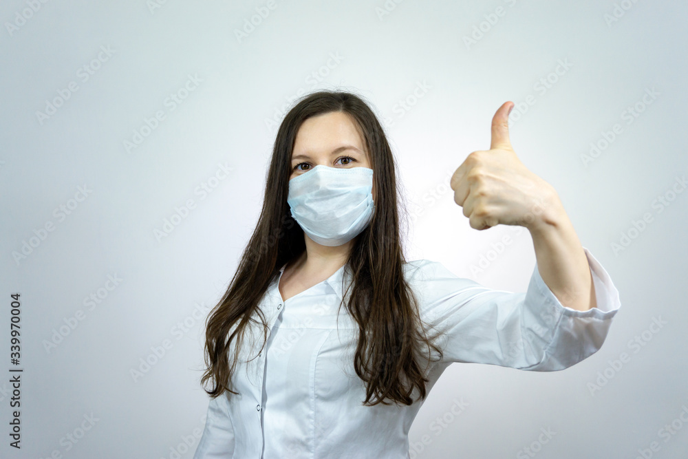 Covid19, coronavirus, female doctor show ok, thumb up, wear medical mask to prevent catching virus, white coat Covid19, coronavirus, female doctor show ok, thumb up, wear medical mask to prevent catching virus, white coat