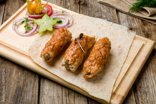 Lula kebab chicken on wooden table