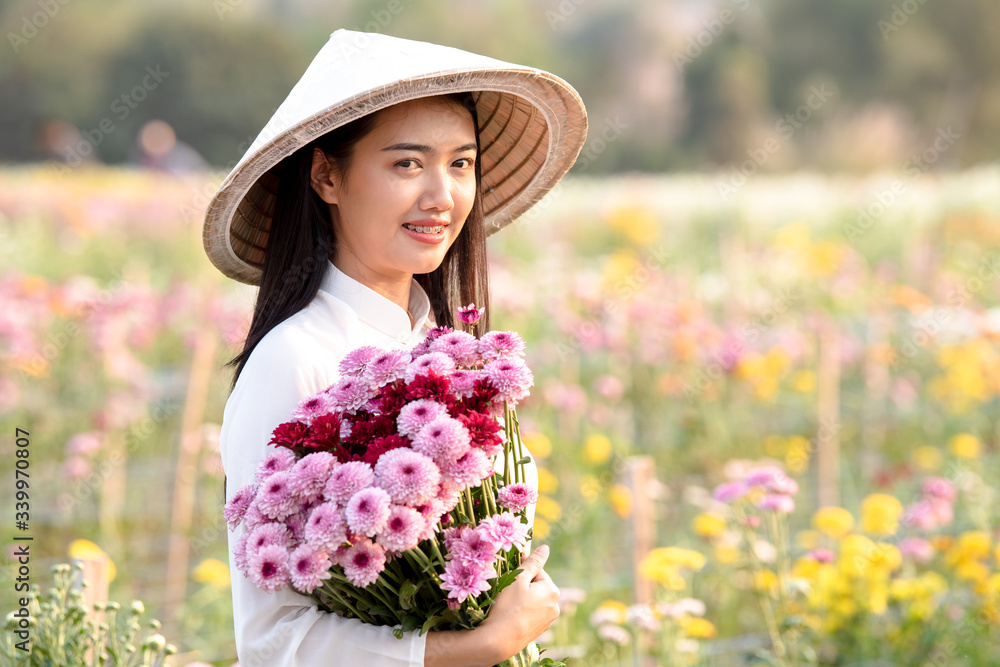 A beautiful Asian woman with a flower field.