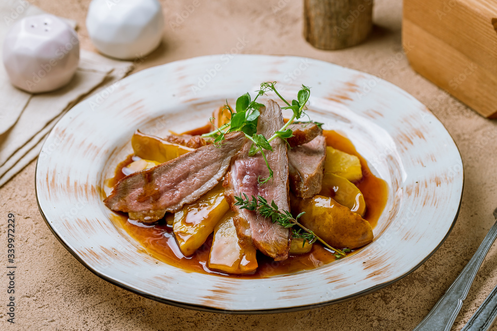 Duck breast with berry sauce and potatoes